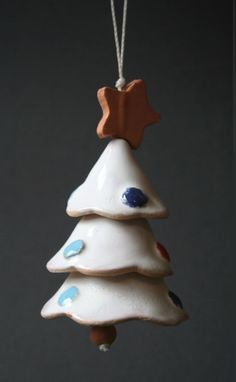 a ceramic christmas tree ornament hanging from a string