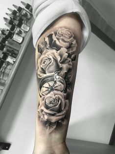 a person with a clock and roses on their arm