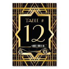 a black and gold table number card with an old car on the front, surrounded by golden lines