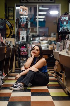 a woman sitting on the floor in a store