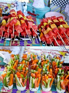 there are many fruits and vegetables on the table with toothpicks in each one