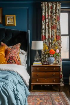 a bed room with a neatly made bed next to a night stand and a window