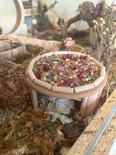 a wooden bowl filled with lots of dried flowers