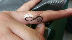 a person with a small tattoo on their finger