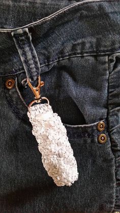 a pair of jeans with a keychain attached to it