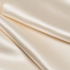 This heavy silk satin men's opera/tuxedo scarf is ideal for occasions that demand both formality and style. At the same time it can pair seamlessly with anything from tailored suits to casual jeans, adding a touch of Italian sophistication to any ensemble. I choose this shade of off-white to harmonize with every shade of white, as every white shirt is different. Made from thick, luxurious silk satin that offers a soft, subtle sheen. Details Long and just the right width: Approx. 8.5" x 70" (22cm x 180cm). This allows for an elegant look that sets you apart. Double thickness: Tubular construction. This means that there is finished silk on the front and the back so no matter how you wear it, it looks great. Eyelash hem: The short ends are left open with an eyelash hem. This keeps the scarf f