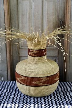 a basket with some grass in it sitting on a table