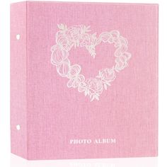 a pink photo album with white flowers in the shape of a heart on it's cover