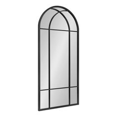 an arched mirror with black frame on a white background