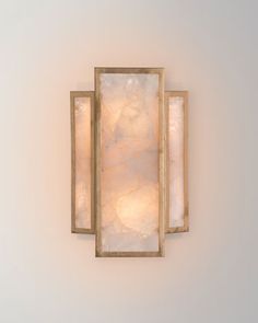 a light fixture mounted to the side of a wall with two lights on each side