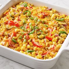 a casserole dish filled with corn and vegetables