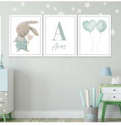 two posters with animals and balloons hanging on the wall in a child's room