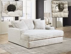 a white couch sitting on top of a hard wood floor next to a wall filled with pictures