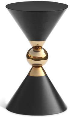 a black and gold vase sitting on top of a table