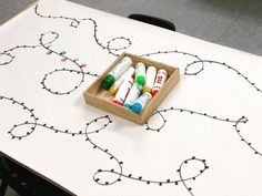 several crayons in a wooden box sitting on top of a table