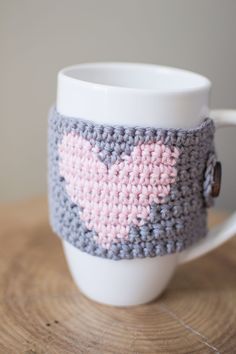 a knitted coffee cup with a heart on it