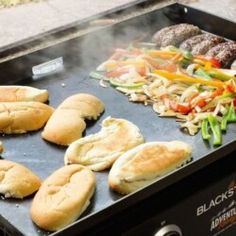 hot dogs and hamburgers cooking on an outdoor grill