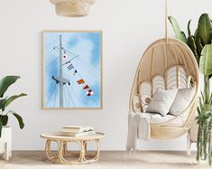 a room with a hanging chair, potted plants and a painting on the wall