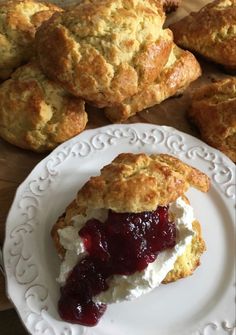 scones with jam and cream on a white plate