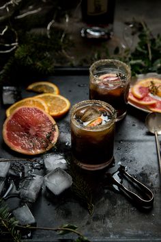 grapefruit cocktails with orange slices and rosemary garnish