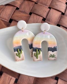 the earrings are made out of wood and have cactus designs on them