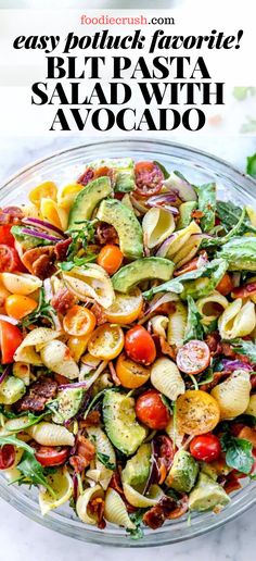 a bowl full of pasta salad with avocado on the side and text overlay