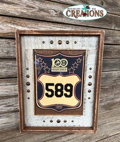 an old fashioned sign is hanging on the side of a wooden building with metal rivets