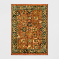 an orange and green rug on a white wall