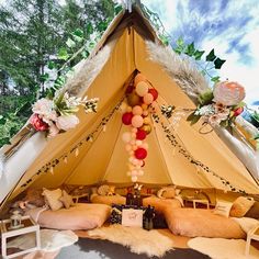 a tent with pillows and balloons in it