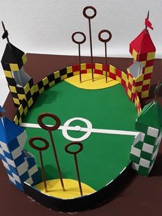 a cake made to look like a miniature baseball field with flags and checkers on it