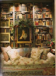 a living room filled with lots of books and furniture