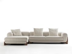 a white couch with four pillows on it