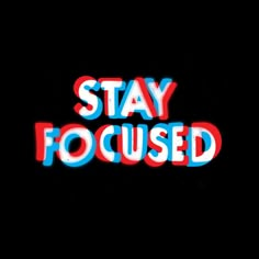 the words stay focused are lit up in red, white and blue letters on a black background