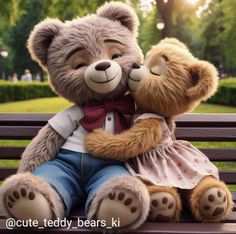 two teddy bears are sitting on a bench