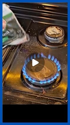 an image of a gas stove that is being used to cook food on the burners