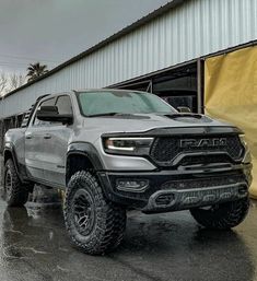 a gray truck parked in front of a building