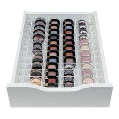 an open drawer filled with lots of different colored eyeshades