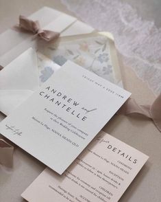 the wedding stationery is laid out on top of each other