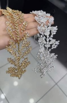 two gold and silver hair combs in the shape of flowers, leaves and snowflakes