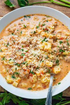 a white bowl filled with pasta and meat