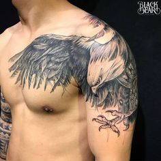 a man with an eagle tattoo on his arm and chest is standing in front of a black background