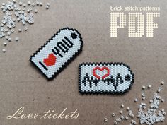 two cross stitched patches with the words love tickets and i love you on them