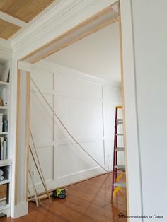 an empty room with white walls and wooden floors is being worked on by a painter