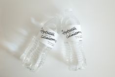 two bottled water bottles sitting next to each other