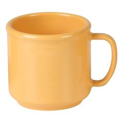 a yellow coffee cup sitting on top of a white table