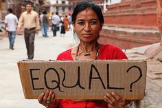 a woman holding a sign that says equal?