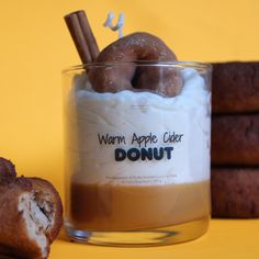 an apple cider donut in a glass with cinnamon sticks