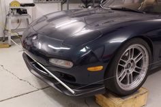 a black sports car parked in a garage