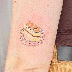 a small piece of cake on the left side of the arm, with little stars around it