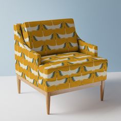 a yellow chair sitting on top of a white floor